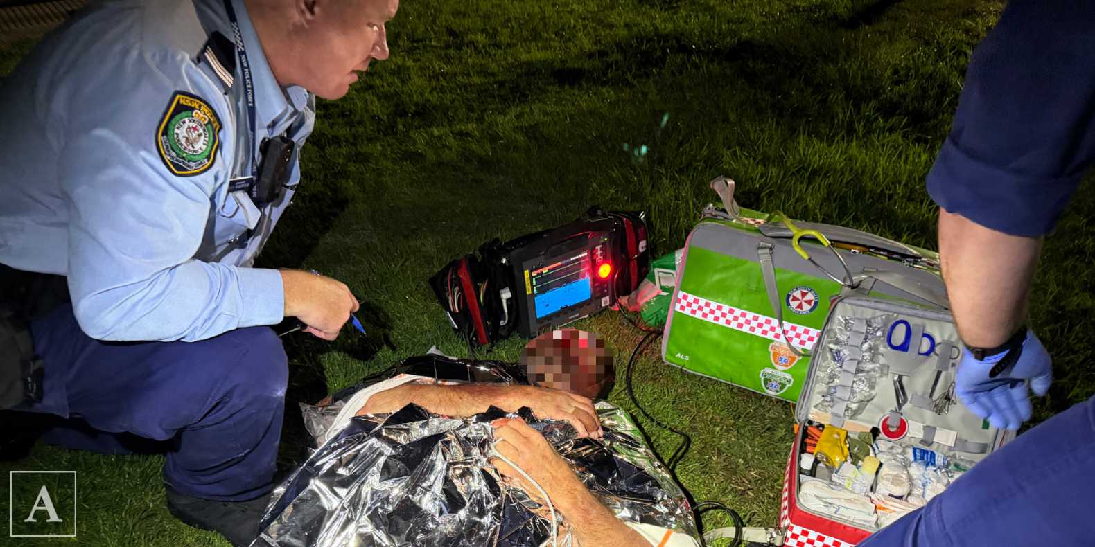NSW Police and NSW Ambulance paramedics treat a men who was bashed at Dee Why NSW Police and NSW Ambulance paramedics treat a men who was bashed at Dee Why